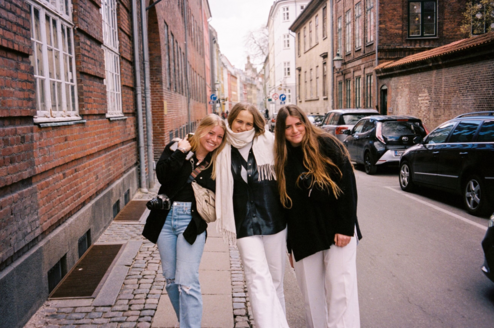 Three students walking through a street